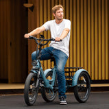 Hombre conduciendo el triciclo eléctrico EU-F20 Mate azul para desplazamientos urbanos